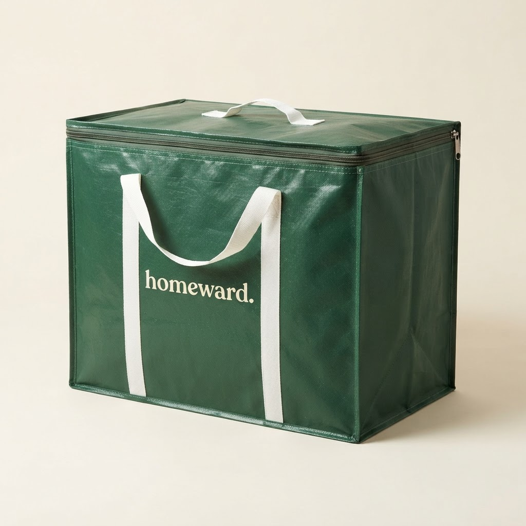The Homeward reusable moving bag: a large structured dark forest-green moving bag with a full zippered lid, reinforced corners and strong white webbing handles